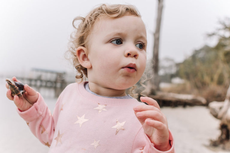 little girl holding seashell