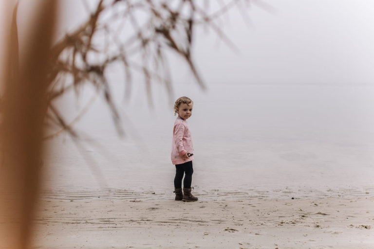 little girl walking through fog