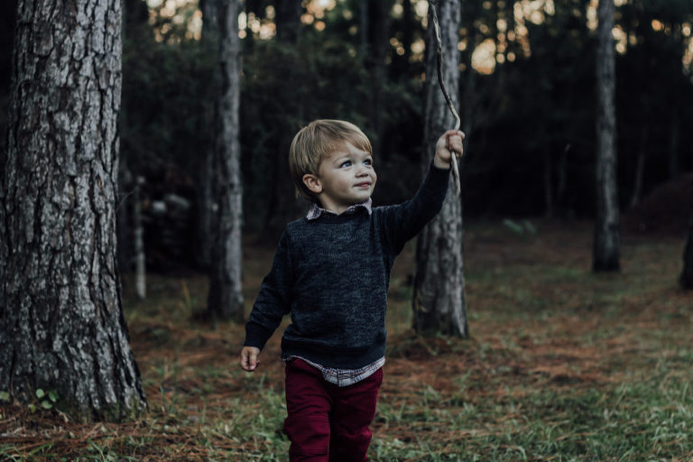 child playing with stick outside
