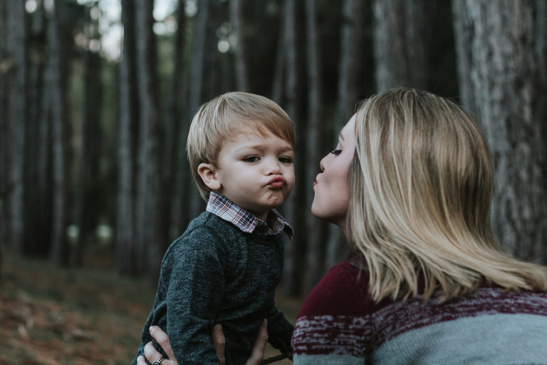 mother and child blowing kiss
