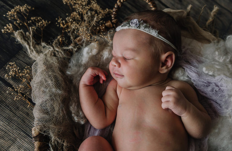 newborn baby girl smiling