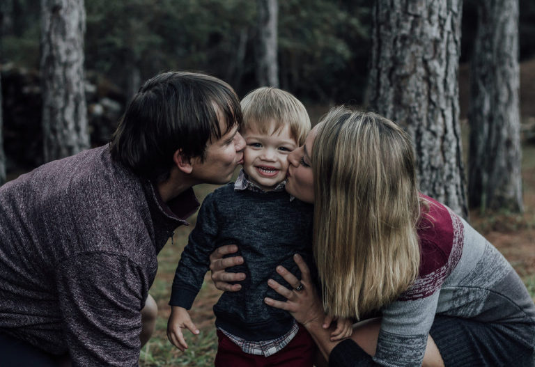 parents kissing child