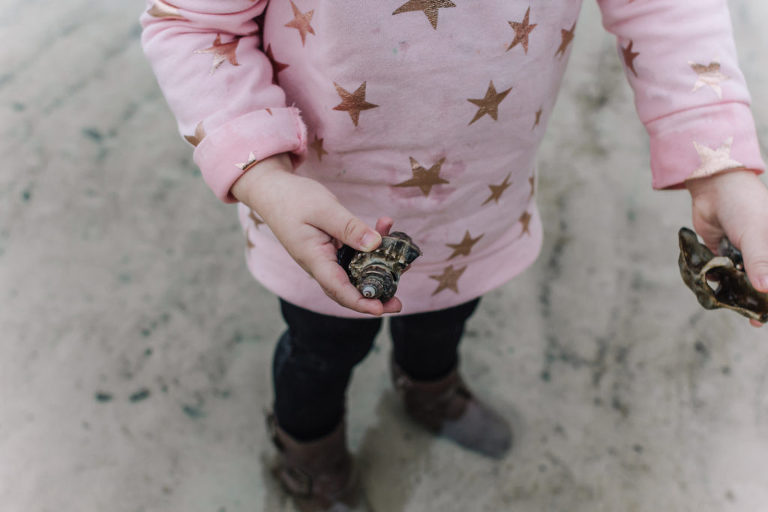 little girl holding seashell