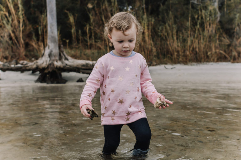 little girl walking in water