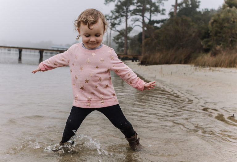 little girl splashing in water